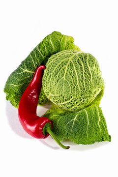Head of Savoy cabbage and red sweet pepper on a white background