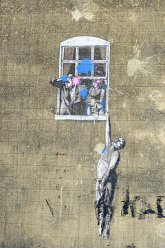 Banksy's Well Hung Lover Street Art Mural in Bristol, England