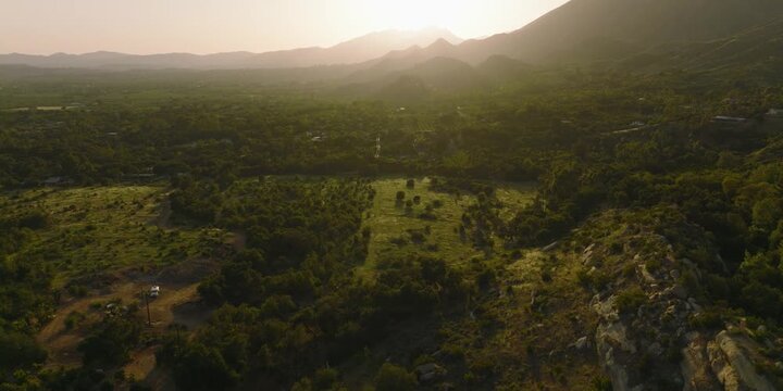 Aerial Tilt Up Reveal of Green Valley and Mountain at Golden Hour