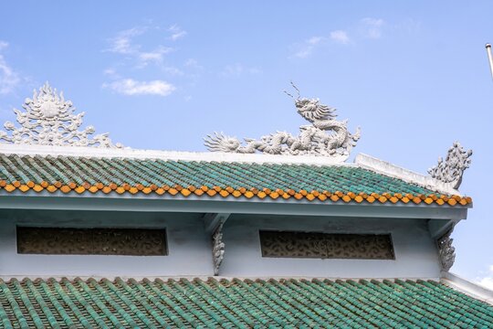 Dragon reliefs on a green tiled roof in Da Lat Vietnam