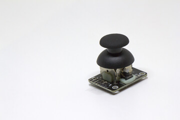 Small thumb joystick breakout board with push button on white background with copy space © Engin
