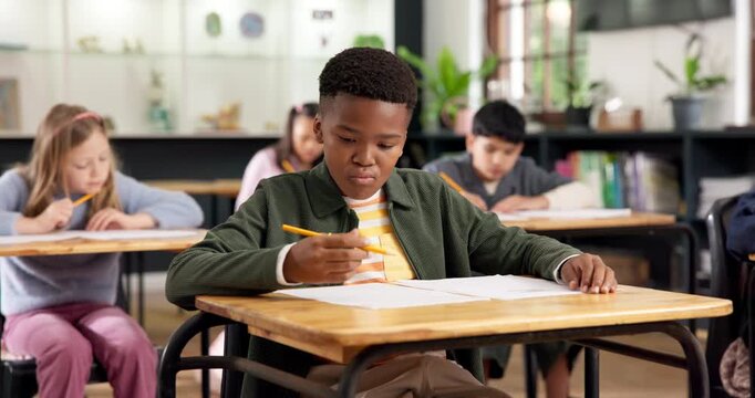 Education, kid and problem solving with test in classroom for academic assessment, knowledge or quiz. Exam, student learning and boy thinking in school, writing on paper and multiple choice questions