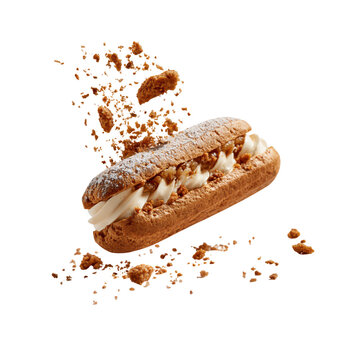 Cream filled eclair with cookie crumbs mid-air during celebration isolated on transparent background