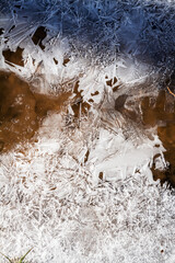 Winter ice background. Frozen water texture, macro view. Frost river close up, top view. Ice on flowing river. © Taigi