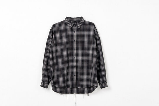 Black grey plaid long sleeve shirt with raw frayed hem flat lay on white background, men casual check shirt product shot