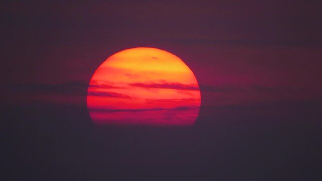 Huge fiery sun disk over ocean