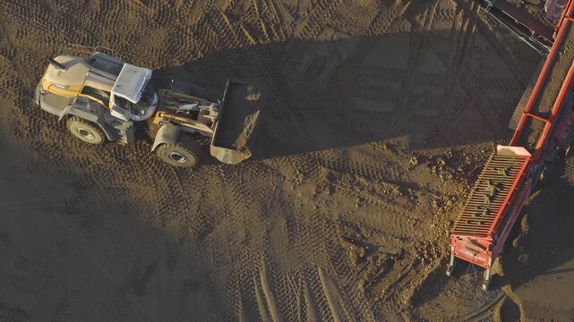 Drone aerial of large mineral sand and gravel quarry mine in southern midwest Ohio for resource mining for manufacturing building materials across United States construction at open-pit excavation sit