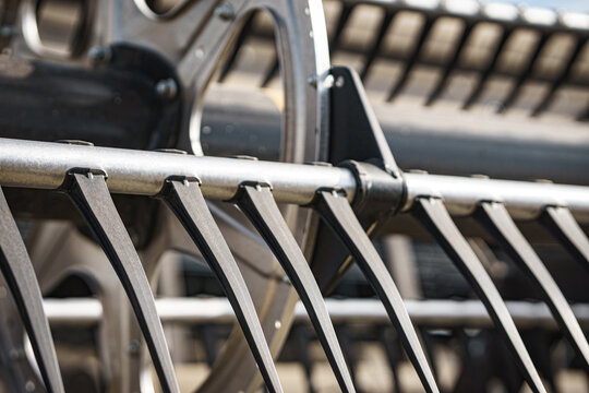 View of the metal tines and reel of a modern combine harvester during a canola harvest in Cherkasy, Cherkasy Oblast, Ukraine.