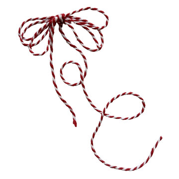Red and white striped baker's twine double bow with swirling ends isolated on white background. Festive cotton string bow for Christmas packaging.