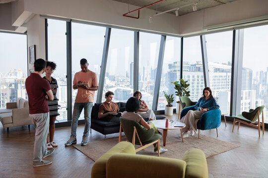 Staff waiting for casual meeting to start in a lounge