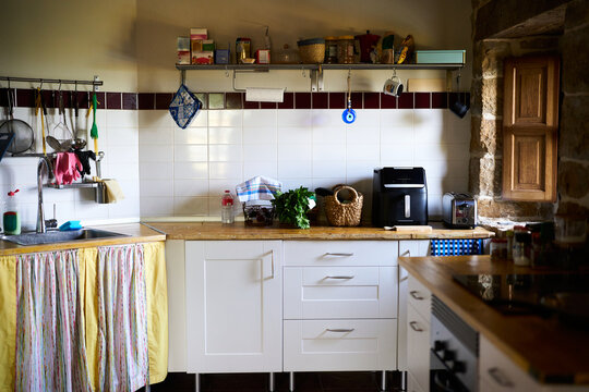 Modern and rustic kitchen interior with appliances and cooking items