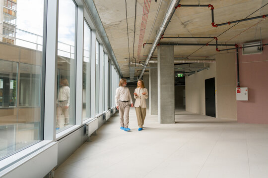 People Walk in a Building During a Construction Phase