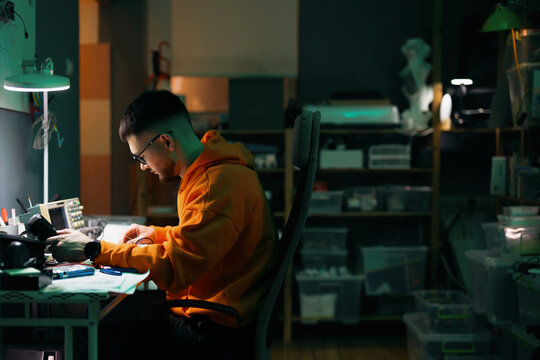 Young Electronics Technician Repairing Circuit Board In Workshop