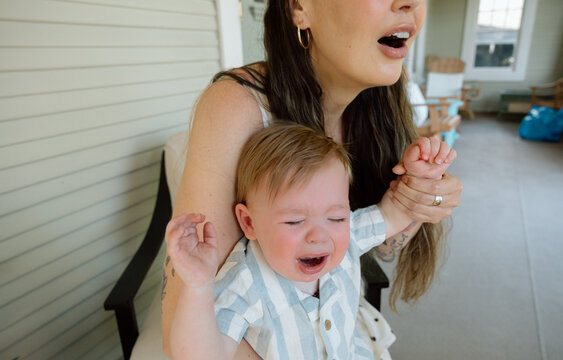 Candid mother comforting crying toddler with emotional distress