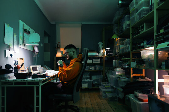 Programmer Working Late in Electronics Workshop