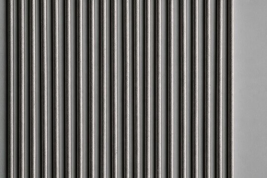 Vertical metal rods creating a repetitive pattern and modern texture