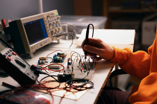 Electronics Engineer Testing Breadboard Circuit