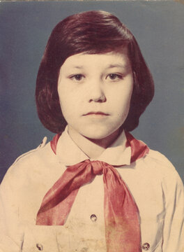 A young girl in a red pioneer necktie, school portrait 1975