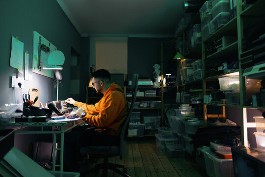 Young Engineer Working on Electronics in Home Workshop