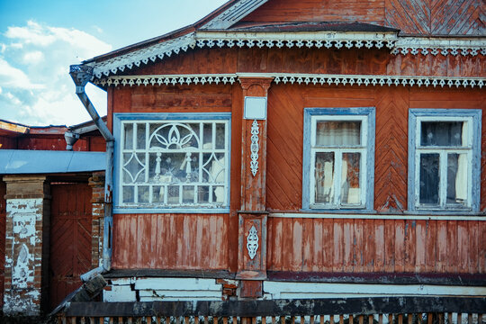 Old wooden house with distinct architecture details in sunlight