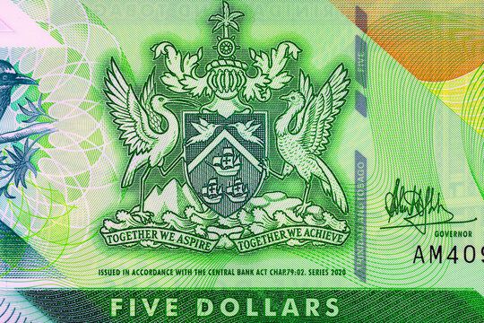 Macro detail of the Trinidad and Tobago 5 Dollar polymer banknote featuring the National Coat of Arms. Plastic money Trinidad and Tobago