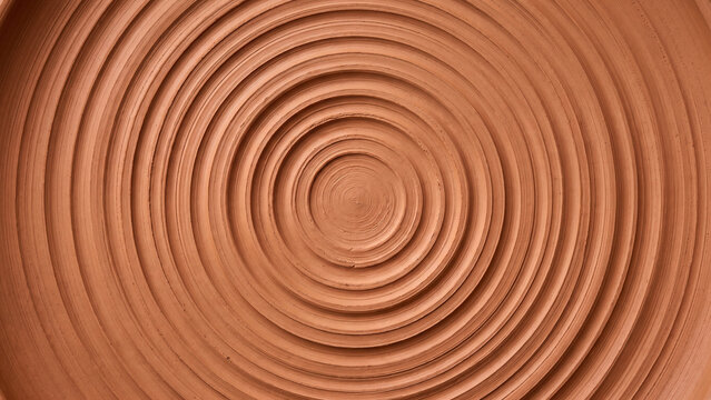 Close up of brown terracotta clay pot bottom with concentric circle pattern