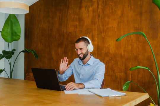 Smiling executive waving on video call