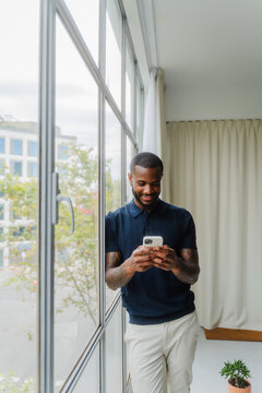Male professional smiling while using smartphone