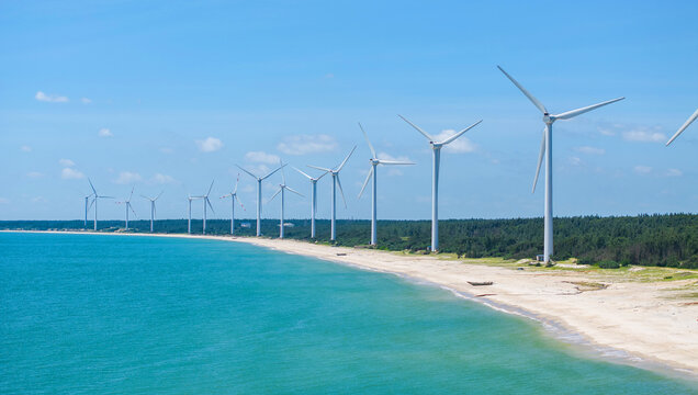 Coastal wind farm along beach and sea