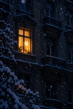 Glowing Christmas Star in the Window of a Snow-Covered Historic Building as an Atmospheric Advent Scene