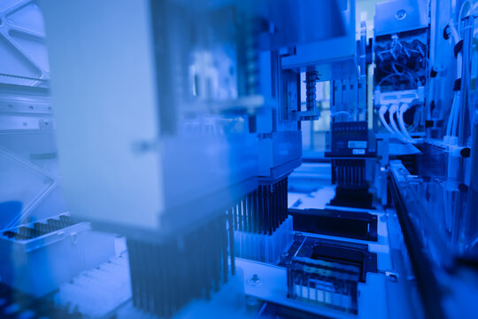 Blood test tube in high-tech lab machine processes for blood chemistry.Biological samples using test tubes and automated systems.Advanced technology in a research environment laboratory concept.