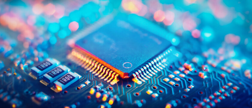 Computer Microchips and Processors on Electronic circuit board. Technology microelectronics concept background. Macro shot, shallow focus.
