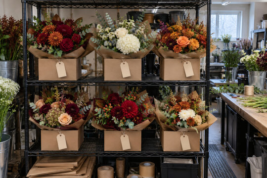 Boxed bouquet orders staged in a florist workroom