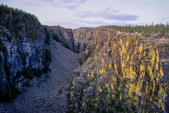 Jutulhogget Canyon in Norway with dramatic rock walls and rugged landscape at dusk