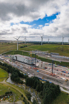 Aerial view of the Green Mountain SVG-Undheim data center construction site, featuring industrial buildings, cranes, and wind turbines in a rural landscape in Undheim, Rogaland, Norway.
