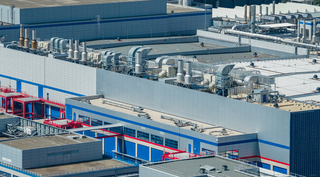 Aerial view of the STMicroelectronics facility featuring rooftop ventilation systems, industrial exhaust ducts, and cleanroom infrastructure in Crolles, Auvergne-Rhone-Alpes, France.