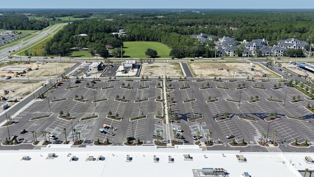 Aerial view of a large, newly paved parking lot at the intersection of Foundry Lane and International Golf Parkway, with marked spaces in World Golf Village, Florida, United States.