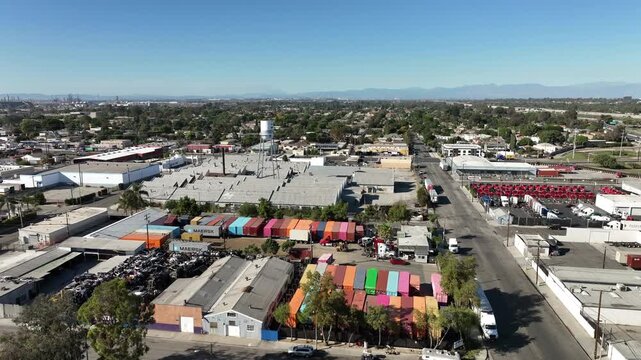 Long Beach, California, USA - Drone View of Westside Industrial Warehouses, Factories and Water Tower Near Pacific Coast Highway on a Bright Day