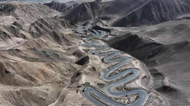 Aerial view of Panlong Ancient Road winding through Xinjiang desert mountains