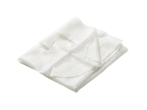 Folded white sheet face mask lying neatly isolated against a pure bright background surface