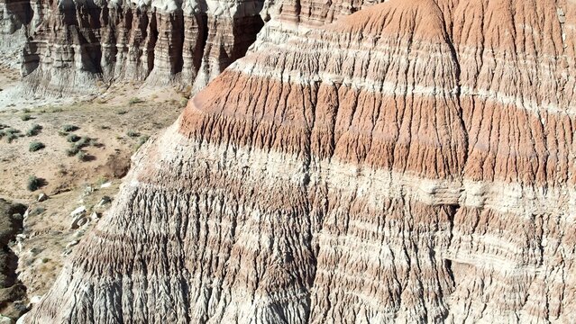 Aerial view of the eroded rock formations and colorful sedimentary layers of the Arizona Badlands in Gila County, Arizona, United States.