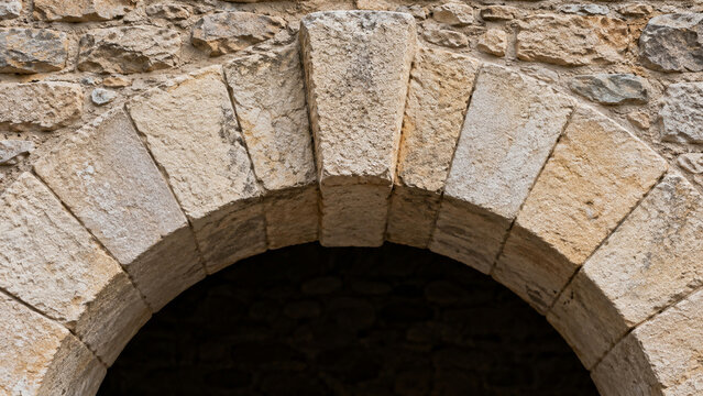 Romanesque style stone arch with projecting keystone