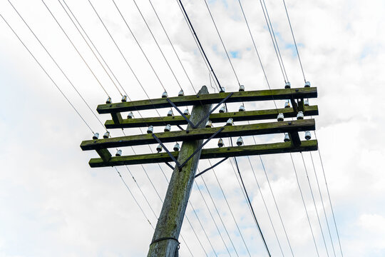 Old wooden utility pole with crossarms