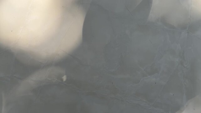 Hard sunlight shadow moving across square ceramic floor tiles, geometric architectural interior backdrop