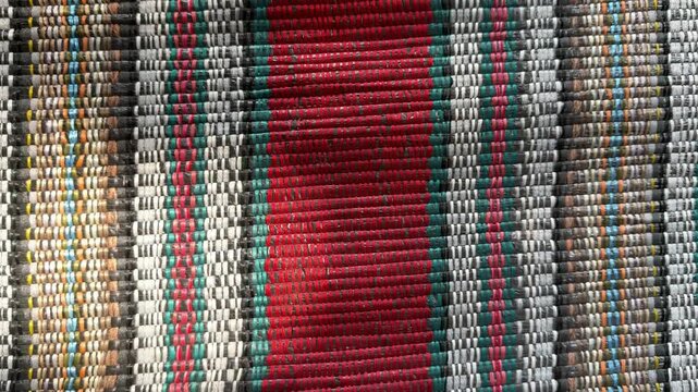 Straight vertical lines of woven raffia string with subtle moving shadow, traditional interlaced polypropylene twine backdrop, 60fps 4K video