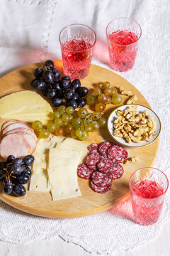 Cheese and Salami Appetizer Board with Grapes, Nuts and Rose Wine