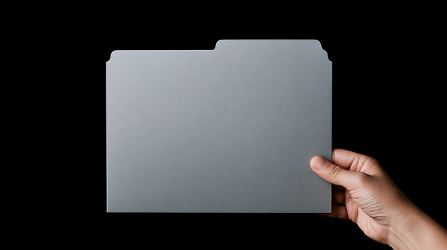 A person hand hold a blank grey file folder against a solid black background, perfect for corporate identity mockup and office concept use