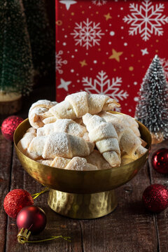 Traditional Jam-Filled Crescent Cookies with Powdered Sugar and Christmas Holiday Decor