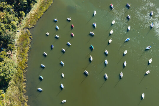 Sailboats are moored in a calm saltwater cove, Arey's Pond, in Pleasant Bay, Cape Cod, MA. This east coast region is a popular destination for vacationers and is famous for sailing.