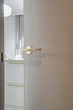 door handle on white wooden door in interior. Knob close-up elements. Door handle, fittings for interior design